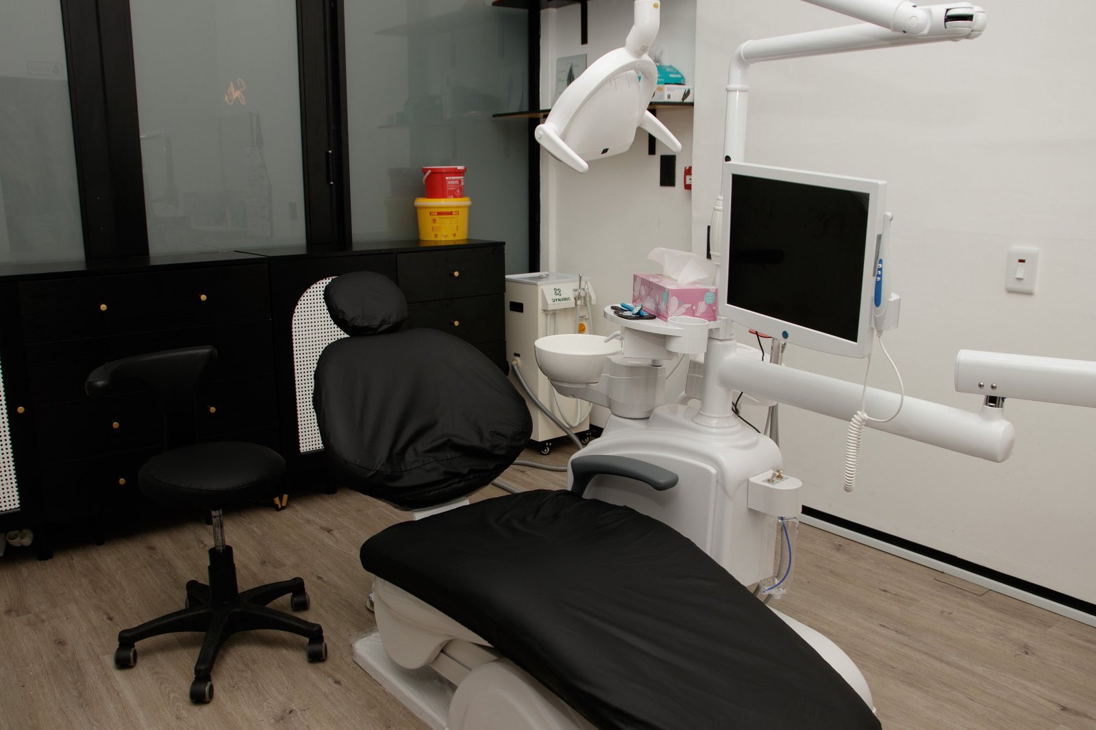 A dental treatment room with a dentist’s chair and equipment